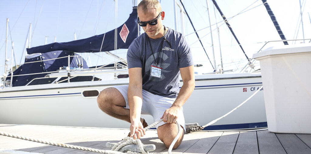 featured image showing a young man docking a boat wearing a CA Boater's Card